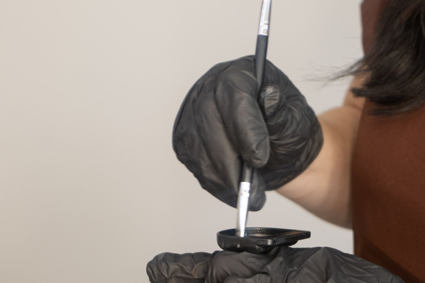 Mixing brow tint with a brush ready for a brow tint and shape